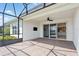 Spacious screened patio with brick flooring, ceiling fan, and sliding glass doors leading into the home at 142 Olympus Way, Kissimmee, FL 34759