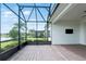 Open-air patio with brick pavers offering views of manicured lawn and a serene lake view at 142 Olympus Way, Kissimmee, FL 34759