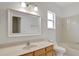 Bathroom with a large mirror over the vanity and a tub/shower combo at 143 Brixham Ct, Kissimmee, FL 34758