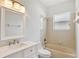 The bathroom offers a tub and shower, along with a vanity and a large mirror at 143 Brixham Ct, Kissimmee, FL 34758
