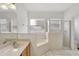 Bathroom with double sinks, a soaking tub, and walk-in shower at 143 Brixham Ct, Kissimmee, FL 34758
