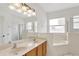 Bright bathroom features double sinks, a soaking tub, walk-in shower, and ample natural light at 143 Brixham Ct, Kissimmee, FL 34758