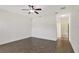 Spacious bedroom features wood-look floors, a ceiling fan, and an ensuite bathroom at 143 Brixham Ct, Kissimmee, FL 34758