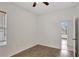 Bedroom with wood-look floors, a ceiling fan, and a sunny window at 143 Brixham Ct, Kissimmee, FL 34758