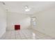 Bright bedroom with a ceiling fan and white tile flooring at 143 Brixham Ct, Kissimmee, FL 34758