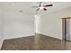 Large bedroom with wood-look floors, a ceiling fan, and a sliding door to the outside at 143 Brixham Ct, Kissimmee, FL 34758