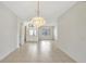 Bright dining room with decorative chandelier and tile flooring at 143 Brixham Ct, Kissimmee, FL 34758