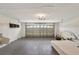 A spacious two-car garage with a white brick interior and an overhead garage door at 143 Brixham Ct, Kissimmee, FL 34758