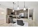 Modern kitchen featuring granite counters, stainless steel appliances, and barstool seating at 143 Brixham Ct, Kissimmee, FL 34758
