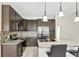 Modern kitchen with granite countertops, stainless appliances, and custom cabinetry at 143 Brixham Ct, Kissimmee, FL 34758