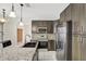 Stylish kitchen boasts granite counters, stainless appliances, and mosaic backsplash at 143 Brixham Ct, Kissimmee, FL 34758