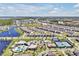 Community aerial showing the community pool, playgrounds, and tennis courts amid a neighborhood setting at 14389 Lanikai Beach Dr, Orlando, FL 32827