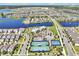 This aerial shows a pool and tennis courts in a neighborhood nestled among lakes, providing recreation and beauty at 14389 Lanikai Beach Dr, Orlando, FL 32827