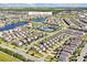 Aerial view of the community highlighting proximity to the amenities center, tennis courts, and pond at 14389 Lanikai Beach Dr, Orlando, FL 32827