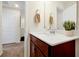 Bathroom with a modern sink, dark wood cabinet, quartz countertop, mirror and neutral tones at 14389 Lanikai Beach Dr, Orlando, FL 32827