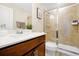 Bathroom features a vanity with dark wood cabinets, quartz countertop, sink and a glass door shower at 14389 Lanikai Beach Dr, Orlando, FL 32827