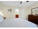 Bedroom with dresser, en-suite bathroom, and neutral colored walls and carpet at 14389 Lanikai Beach Dr, Orlando, FL 32827