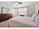 Well-lit bedroom features neutral carpet, large dresser, and an open en-suite at 14389 Lanikai Beach Dr, Orlando, FL 32827