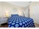 Comfortable bedroom showcasing a blue patterned bed, bedside tables, and a modern decor at 14389 Lanikai Beach Dr, Orlando, FL 32827