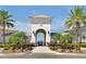 Elegant community entrance with stone accents, lush landscaping, and welcoming design at 14389 Lanikai Beach Dr, Orlando, FL 32827