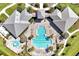 Overhead view of a resort-style community pool with lounge chairs, palm trees, and ample space for relaxation at 14389 Lanikai Beach Dr, Orlando, FL 32827