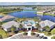 Aerial view of the community pool and lake showcasing a luxurious amenity and beautiful water view at 14389 Lanikai Beach Dr, Orlando, FL 32827