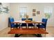 Dining room with seating for six featuring a wood table and blue upholstered chairs at 14389 Lanikai Beach Dr, Orlando, FL 32827