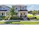 Charming two-story home with lush landscaping, a covered porch, and a welcoming entrance at 14389 Lanikai Beach Dr, Orlando, FL 32827