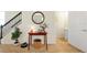 Foyer with small table, round mirror, stairs, and access to powder room at 14389 Lanikai Beach Dr, Orlando, FL 32827