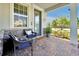 Inviting front porch with brick flooring, comfortable seating, and stylish decor at 14389 Lanikai Beach Dr, Orlando, FL 32827