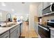 Spacious kitchen with island, stainless steel appliances and connecting living spaces at 14389 Lanikai Beach Dr, Orlando, FL 32827