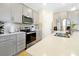Well-lit kitchen features stainless steel appliances, ample gray cabinetry and light countertops at 14389 Lanikai Beach Dr, Orlando, FL 32827