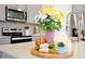 Kitchen island decor includes flowers, candles, and succulents on a wooden tray at 14389 Lanikai Beach Dr, Orlando, FL 32827