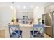 Well-lit kitchen with gray cabinets, stainless steel appliances, and an island with bar seating at 14389 Lanikai Beach Dr, Orlando, FL 32827