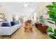 Spacious living room connecting to kitchen, featuring modern decor, tile flooring, and ample lighting at 14389 Lanikai Beach Dr, Orlando, FL 32827