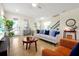 Bright living room featuring modern decor, tile flooring, and plenty of natural light at 14389 Lanikai Beach Dr, Orlando, FL 32827