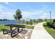 Picturesque picnic area with tables overlooking a serene lake, perfect for outdoor dining at 14389 Lanikai Beach Dr, Orlando, FL 32827