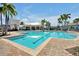Community pool with crystal-clear water, palm trees, and comfortable lounge chairs for residents at 14389 Lanikai Beach Dr, Orlando, FL 32827