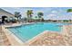 Inviting community pool with clear water, ample seating, and lush landscaping for relaxation at 14389 Lanikai Beach Dr, Orlando, FL 32827