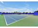 Well-maintained tennis court featuring blue and green surfaces and a secure fence, ideal for sports enthusiasts at 14389 Lanikai Beach Dr, Orlando, FL 32827