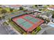 Aerial view showcases a tennis court and playground with a golf course and lakes in the background at 1470 Lake Side Ave, Davenport, FL 33837