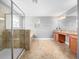 Bathroom featuring glass enclosed shower and separate vanity with granite countertop at 1470 Lake Side Ave, Davenport, FL 33837