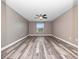 This bedroom features sleek, modern floors, a ceiling fan, and a window that provides natural light at 1470 Lake Side Ave, Davenport, FL 33837