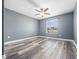 This bedroom features sleek, modern floors, a ceiling fan, and a window that provides natural light at 1470 Lake Side Ave, Davenport, FL 33837