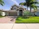 Charming two-story home with tile roof, well-maintained landscaping, and inviting curb appeal at 1470 Lake Side Ave, Davenport, FL 33837