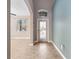 Foyer features a decorative glass door, window above and tile floors that flow into the house at 1470 Lake Side Ave, Davenport, FL 33837