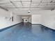 Spacious garage with a painted floor, overhead lighting, and ample storage space at 1470 Lake Side Ave, Davenport, FL 33837