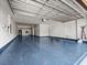 Spacious garage with a painted floor, overhead lighting, and ample storage space at 1470 Lake Side Ave, Davenport, FL 33837