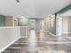 Open hallway with hard wood floors and blue and tan walls at 1470 Lake Side Ave, Davenport, FL 33837