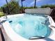 Close-up of a hot tub filled with sparkling water and surrounded by lush greenery at 1470 Lake Side Ave, Davenport, FL 33837